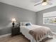 Cozy bedroom with a ceiling fan and natural light from the window at 3501 Sarazen Dr, New Port Richey, FL 34655