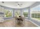 Cozy breakfast nook with many windows and a ceiling fan at 3501 Sarazen Dr, New Port Richey, FL 34655