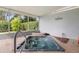 Covered patio features a relaxing hot tub and decorative stone accents at 3501 Sarazen Dr, New Port Richey, FL 34655
