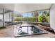 Inviting hot tub on screened patio with lush, private landscaping views at 3501 Sarazen Dr, New Port Richey, FL 34655