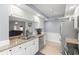 Bright kitchen featuring granite countertops, stainless steel appliances, and white cabinetry at 3501 Sarazen Dr, New Port Richey, FL 34655