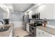Well-lit kitchen with stainless steel appliances, granite countertops, and white cabinetry at 3501 Sarazen Dr, New Port Richey, FL 34655