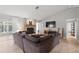 Inviting living room featuring a stone fireplace, vaulted ceiling, and comfortable seating arrangement at 3501 Sarazen Dr, New Port Richey, FL 34655