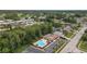 Beautiful community pool surrounded by lush greenery and charming neighborhood streets, perfect for relaxation at 3501 Sarazen Dr, New Port Richey, FL 34655