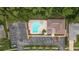 Top-down shot of the inviting community pool and parking lot, providing relaxation and convenience in a serene setting at 3501 Sarazen Dr, New Port Richey, FL 34655
