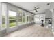 Bright sunroom with exercise equipment and a view of the backyard at 3501 Sarazen Dr, New Port Richey, FL 34655