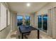 Elegant dining room showcasing a modern table, comfortable seating, and sliding glass doors for seamless outdoor access at 36915 Sagemoor Dr, Zephyrhills, FL 33541