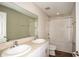 Bathroom featuring double sinks, a shower-tub combo and modern fixtures at 36933 Sagemoor Dr, Zephyrhills, FL 33541