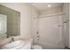 Clean bathroom featuring shower-tub combination, modern vanity, and tile surround at 36933 Sagemoor Dr, Zephyrhills, FL 33541