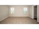 Bright, carpeted bedroom featuring two windows that offer natural light at 36933 Sagemoor Dr, Zephyrhills, FL 33541