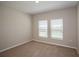 Cozy bedroom featuring soft carpeting, natural light, and neutral paint at 36933 Sagemoor Dr, Zephyrhills, FL 33541