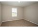 Bedroom with a window and neutral carpeting, creating a cozy and inviting atmosphere at 36933 Sagemoor Dr, Zephyrhills, FL 33541