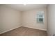 Bedroom with a window and neutral carpeting, creating a cozy and inviting atmosphere at 36933 Sagemoor Dr, Zephyrhills, FL 33541