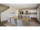 Open-concept dining area with wood-look floors leading to the kitchen at 36933 Sagemoor Dr, Zephyrhills, FL 33541