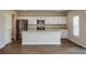 Contemporary kitchen with a large island, stainless steel appliances, and sleek white cabinetry at 36933 Sagemoor Dr, Zephyrhills, FL 33541
