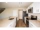 Modern kitchen boasting white cabinets, stainless steel appliances, and wood-look floors at 36933 Sagemoor Dr, Zephyrhills, FL 33541