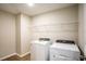 Laundry room featuring a washer and dryer with wire rack shelving for storage at 36933 Sagemoor Dr, Zephyrhills, FL 33541