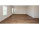 Open living room features modern flooring, large windows, and neutral paint at 36933 Sagemoor Dr, Zephyrhills, FL 33541