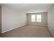 Large living area with soft carpeting, natural light, and neutral paint at 36933 Sagemoor Dr, Zephyrhills, FL 33541