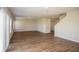 Spacious living area with hardwood floors, neutral paint, and stairway access at 36933 Sagemoor Dr, Zephyrhills, FL 33541