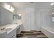Bathroom featuring double sinks, a tub and modern fixtures at 4129 Marlow Loop, Land O Lakes, FL 34639