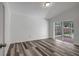Bedroom with new flooring and sliding glass doors to a private patio at 4129 Marlow Loop, Land O Lakes, FL 34639