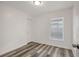 Bedroom featuring modern flooring, a window, and a white door at 4129 Marlow Loop, Land O Lakes, FL 34639