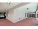 View of the covered patio with a light pink concrete floor, lighting, and access to the screened pool at 4129 Marlow Loop, Land O Lakes, FL 34639