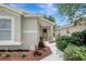 Close up on the entrance to a single story home with well-manicured landscaping at 4129 Marlow Loop, Land O Lakes, FL 34639