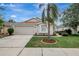Charming single-story home featuring well-manicured landscaping and a two-car garage at 4129 Marlow Loop, Land O Lakes, FL 34639