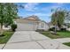 Charming single-Gathering home featuring well-maintained landscaping and a two-car garage at 4129 Marlow Loop, Land O Lakes, FL 34639