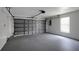 Spacious garage with a large garage door, a window, and plenty of space for parking and storage at 4129 Marlow Loop, Land O Lakes, FL 34639