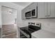 A closer view of the kitchen showing quartz countertop and stainless steel stove and microwave at 4129 Marlow Loop, Land O Lakes, FL 34639