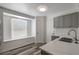 Updated kitchen features white quartz countertops and stainless steel sink, cabinets and new flooring at 4129 Marlow Loop, Land O Lakes, FL 34639