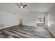 Bright living room featuring vaulted ceilings, stylish gray flooring, and a patio door at 4129 Marlow Loop, Land O Lakes, FL 34639