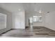 Bright living room featuring vaulted ceilings and stylish gray, wood-look flooring at 4129 Marlow Loop, Land O Lakes, FL 34639