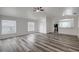 Bright living room featuring vaulted ceilings, stylish gray flooring, and a ceiling fan at 4129 Marlow Loop, Land O Lakes, FL 34639