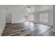 Bright living room featuring vaulted ceilings, stylish gray flooring, and a patio door at 4129 Marlow Loop, Land O Lakes, FL 34639