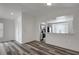 Bright living room featuring vaulted ceilings and stylish gray, wood-look flooring at 4129 Marlow Loop, Land O Lakes, FL 34639