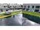 Aerial view of community pond, fountain and modern townhome complex at 4148 Gauge Line Loop, Tampa, FL 33624