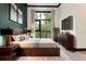 Bedroom with a large window, wood floors, modern furniture, and art at 4148 Gauge Line Loop, Tampa, FL 33624