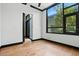 A bright bedroom with large window, light hardwood floors, and black trim at 4148 Gauge Line Loop, Tampa, FL 33624