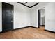 Bedroom featuring wood floors, black trim, and a five-panel door at 4148 Gauge Line Loop, Tampa, FL 33624