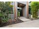 Contemporary home's front entrance boasts modern design, contrasted by lush, vibrant landscaping at 4148 Gauge Line Loop, Tampa, FL 33624