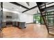 Open-concept kitchen and living area featuring modern appliances, island, and staircase at 4148 Gauge Line Loop, Tampa, FL 33624