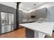Modern kitchen featuring stainless steel appliances, gray cabinets, and white countertops at 4148 Gauge Line Loop, Tampa, FL 33624