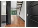 Spacious living room with hardwood floors, black staircase, and natural light from large windows at 4148 Gauge Line Loop, Tampa, FL 33624