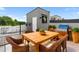 Outdoor dining area featuring a wooden table, seating for four, and a built in gas grill at 4148 Gauge Line Loop, Tampa, FL 33624