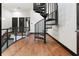 Stylish spiral staircase adds a unique architectural element to this home's interior, complemented by hardwood floors at 4148 Gauge Line Loop, Tampa, FL 33624