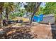 Backyard featuring a car, a jacuzzi, a shed, and tropical trees, surrounded by a wooden fence at 4411 3Rd S Ave, St Petersburg, FL 33711